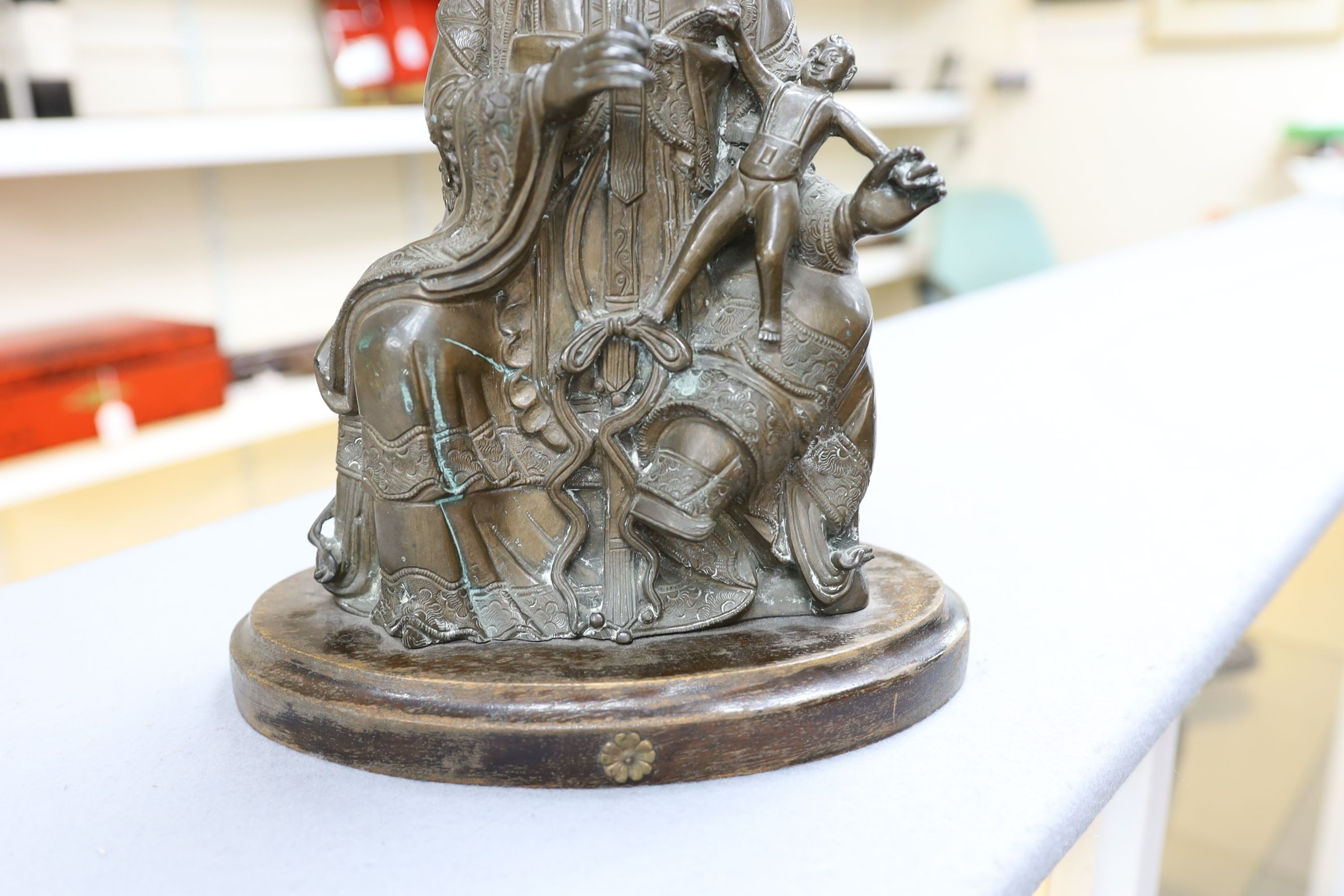 A large Chinese bronze group of Xi Wangmu and a child, late Ming dynasty, 31.5cm high excluding later wood stand